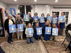group displaying paintings of sailboat